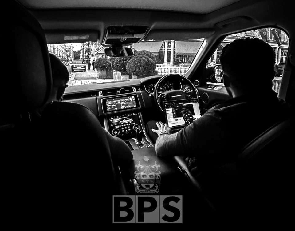 View from the rear seat of a BPS vehicle, the security driver at the wheel in central London