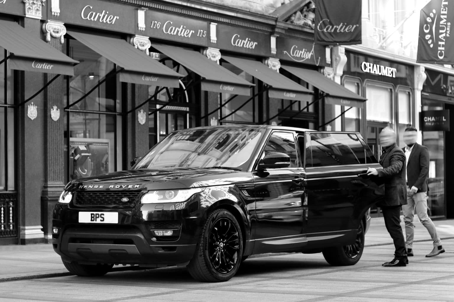 A BPS Range Rover pulled up outside a row of luxury shopfronts, officers at the kerb