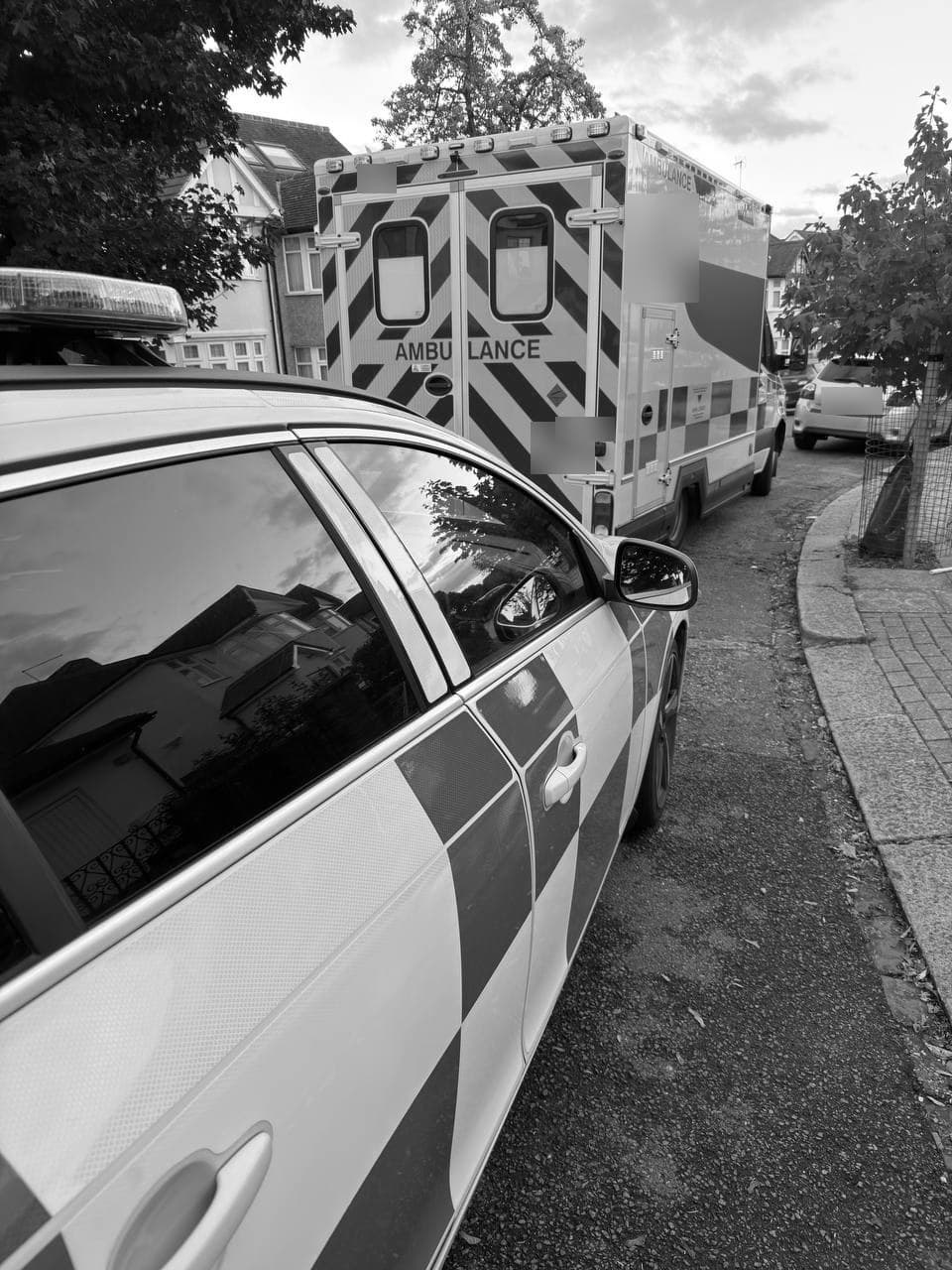 A rapid response car parked behind an ambulance on a residential street
