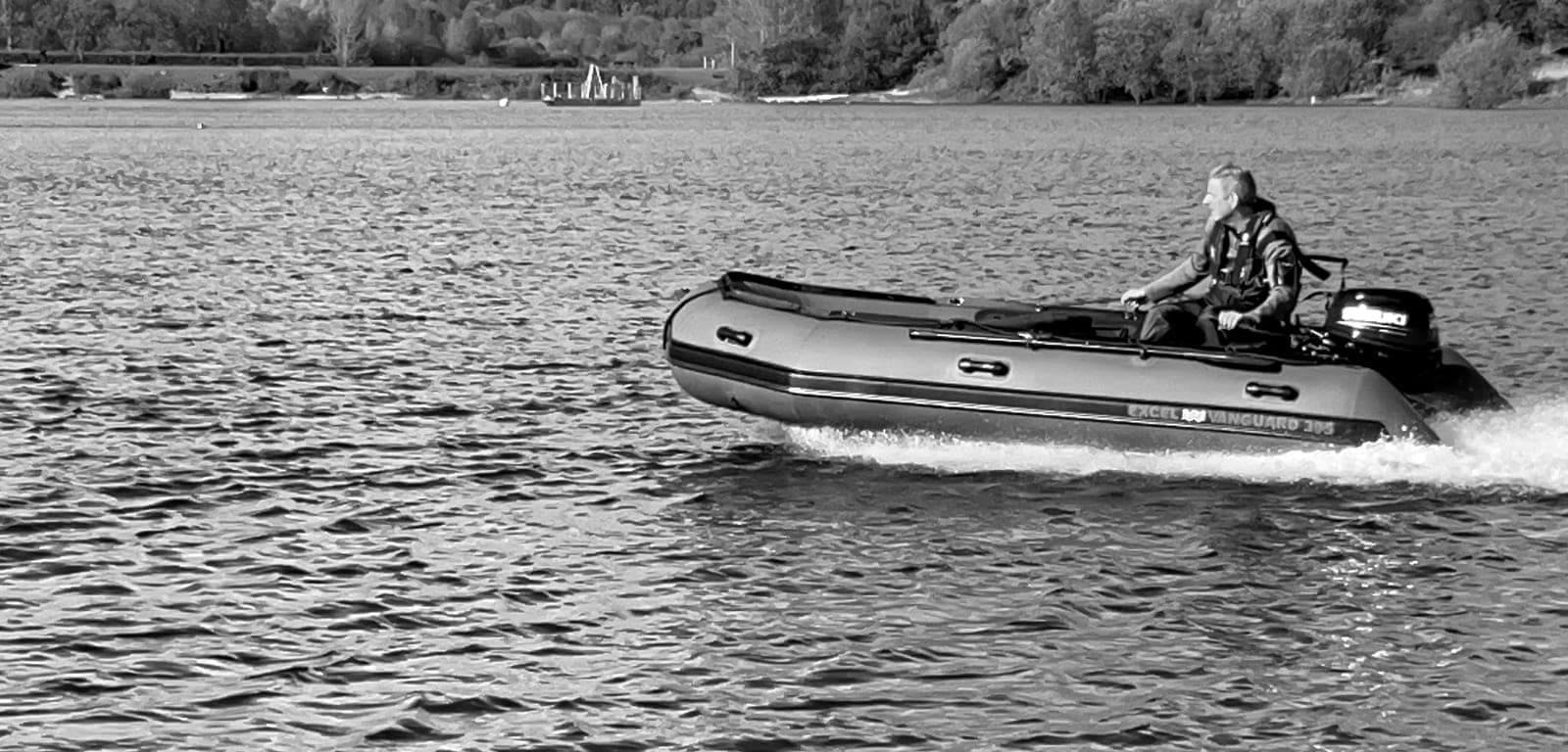 The BPS rescue RHIB under way on open water, an operative at the helm in a lifejacket