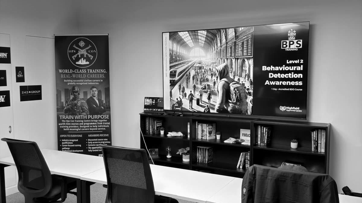 A BPS classroom set out for the Level 2 Behavioural Detection Awareness course, the course title on the screen