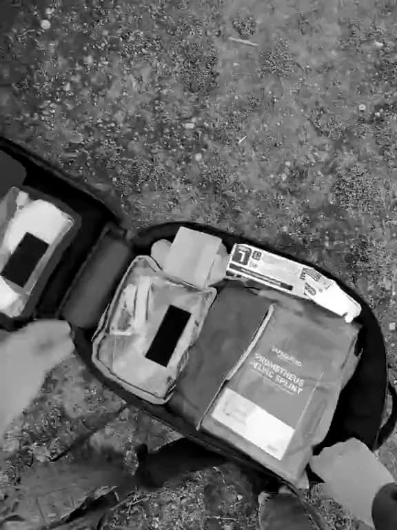 A course member's own view on a BPS medical training exercise: opening a trauma kit, then putting a tourniquet on a role-play casualty's leg